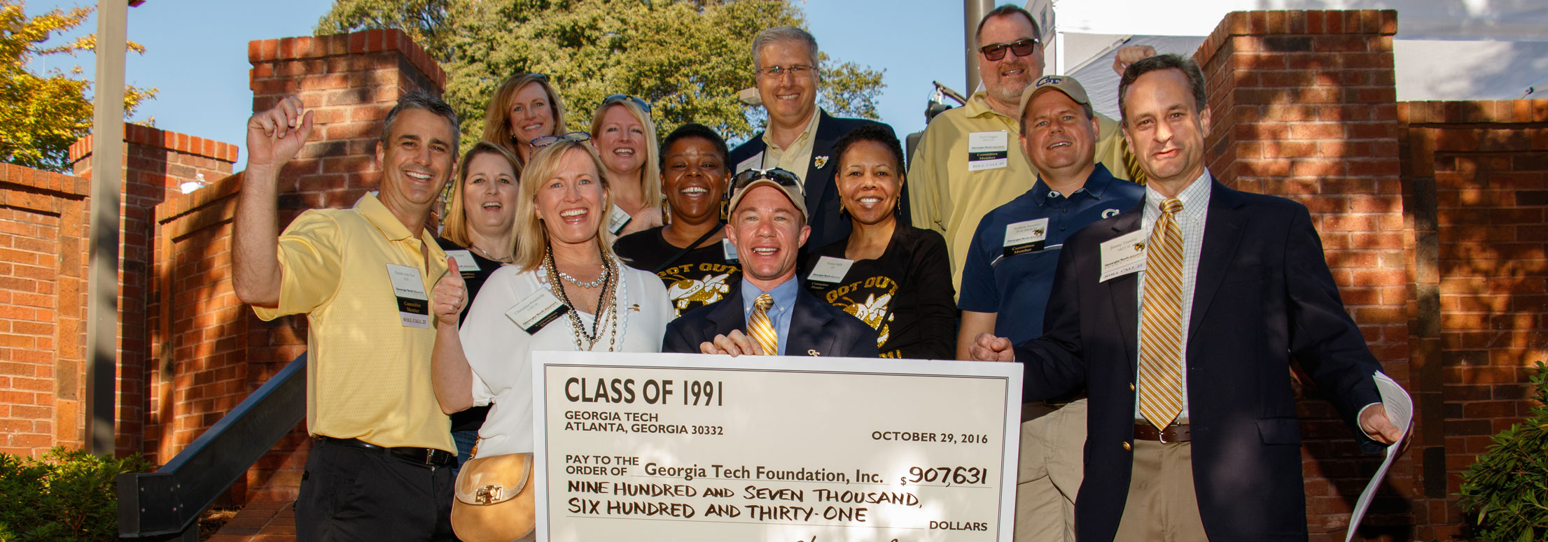The class of 1991 at their 25th reunion holding up their reunion giving check