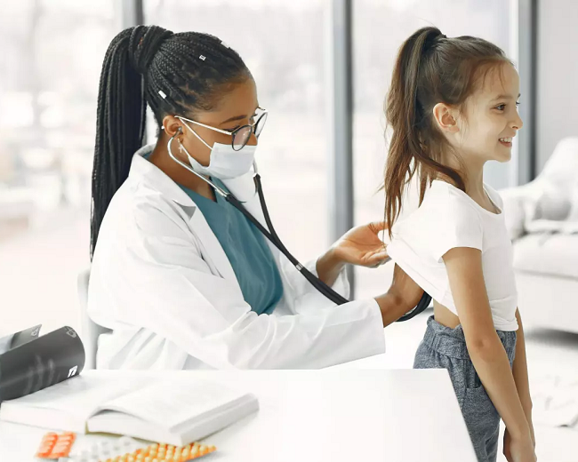 female doctor with stethoscope helping young patient