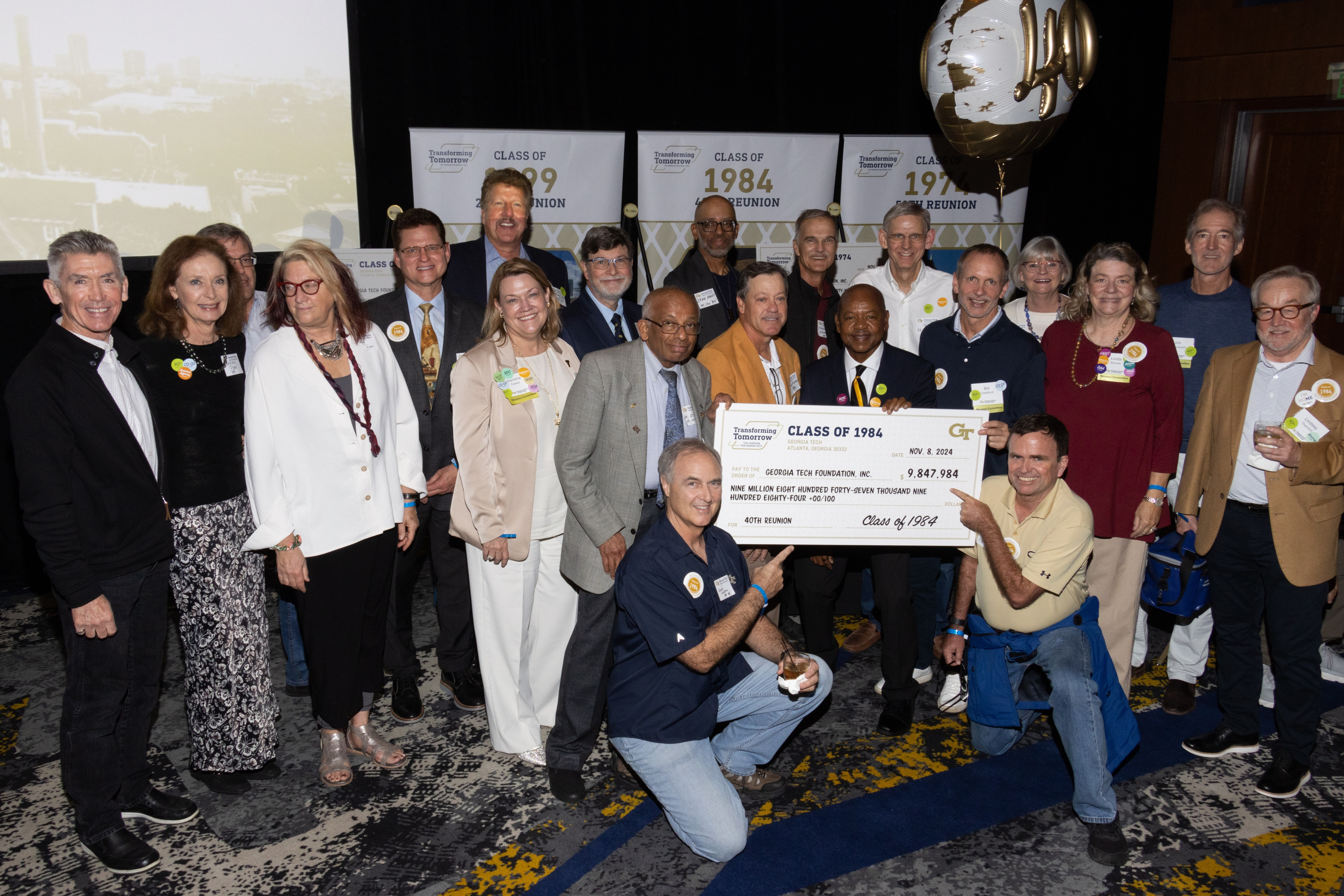 reunion class holding big check