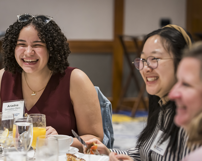 photo of two students and one staff member from scholarship brunch