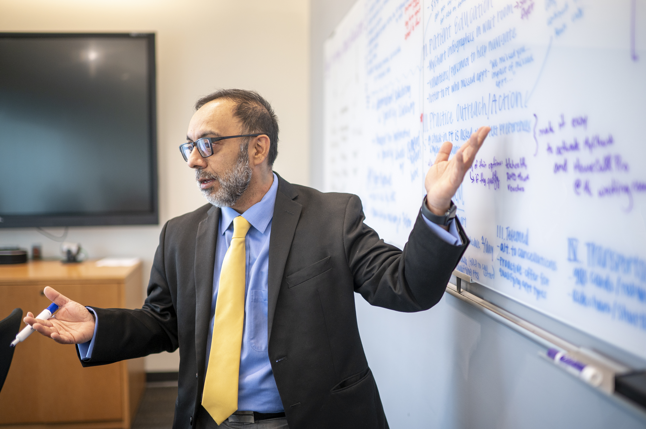 Scheller professor teaching at a whiteboard