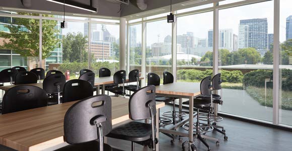 chairs and tables in room with lots of windows