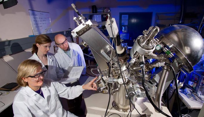 Photo of three Georgia Tech researchers in the lab.